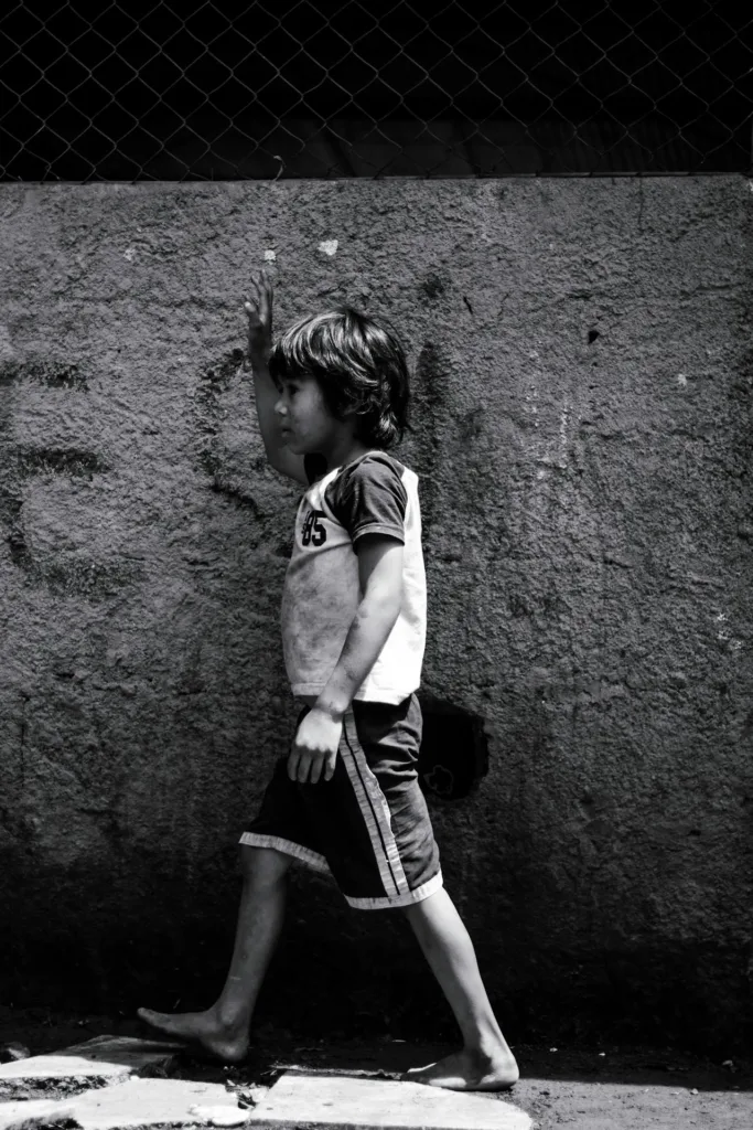 Emotional Neglect in Childhood image credit: Photo by Thom Gonzalez from Pexels: https://www.pexels.com/photo/ethnic-barefoot-boy-walking-on-sidewalk-6836484/